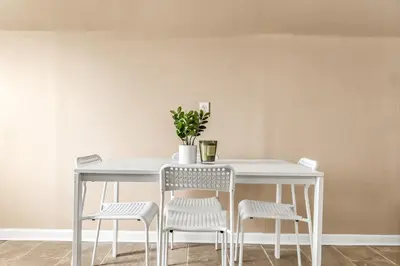 a white table and chairs with a plant on it at Bedroom walking distance to Yale Bridgeport Hospital in Bridgeport