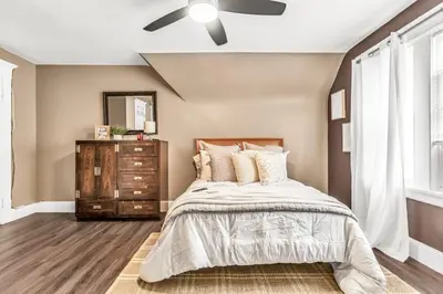 a bedroom with a bed and a ceiling fan at A walk to Yale Bridgeport Hospital in Bridgeport