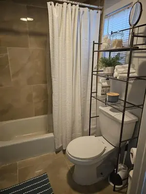 a bathroom with a white toilet and a shower at A walk to Yale Bridgeport Hospital in Bridgeport
