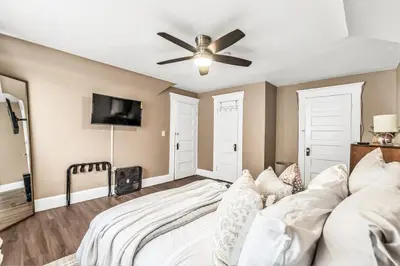 a bedroom with a bed and a ceiling fan at A walk to Yale Bridgeport Hospital in Bridgeport
