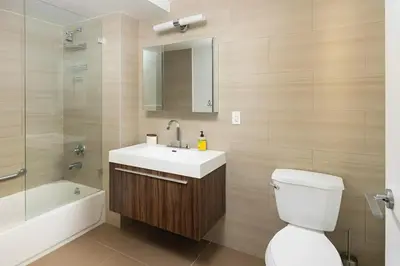 a bathroom with a sink and a toilet and a tub at Large Upper East Side 1BD Elevator Rooftop in New York