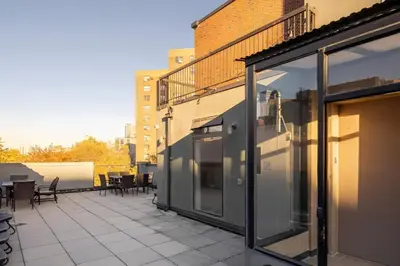 a balcony with glass doors on a building at Large Upper East Side 1BD Elevator Rooftop in New York