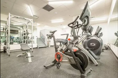 a gym with two exercise bikes and a treadmill at Chic 1BD with Rooftop W/D in Unit Downtown in New York