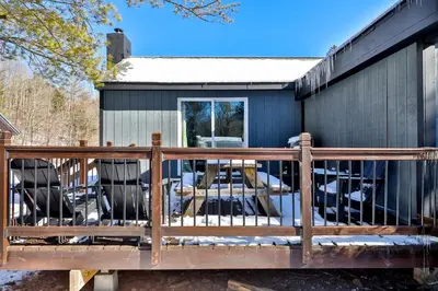 a deck in front of a black house at Matterhorns Hunter Lodge in Hunter