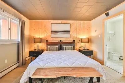 a bedroom with a large bed and two night stands at Matterhorns Hunter Lodge in Hunter