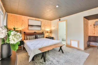a bedroom with a bed and a table at Matterhorns Hunter Lodge in Hunter