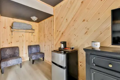 a small kitchen with two chairs and a refrigerator at Matterhorns Hunter Lodge in Hunter