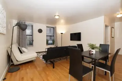a living room with a couch and a table at 2Bed Bliss by Central Park North in New York