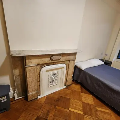 a room with a fireplace and a bed in a room at New York City Guest House 2 in New York