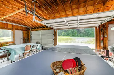 a ping pong table in the center of a house at Fire Pit and On-Site Pond Wooded Walton Home! in Walton