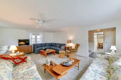 a living room with a couch and a table at Fire Pit and On-Site Pond Wooded Walton Home! in Walton