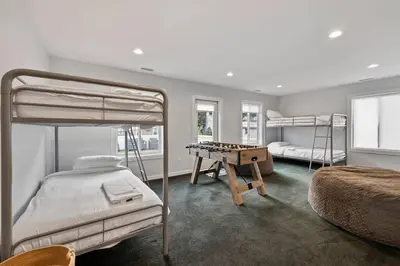 a bedroom with two bunk beds and a chess board at Piermont Waterfront Villa! in Piermont