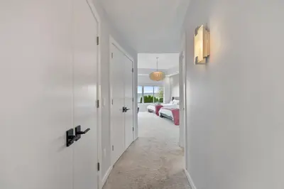 a white hallway with a bed in a bedroom at Piermont Waterfront Villa! in Piermont