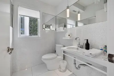 a white bathroom with a toilet and a sink at Piermont Waterfront Villa! in Piermont