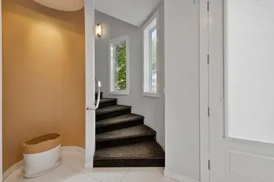 a staircase in a home with a white door and a stair case at Piermont Waterfront Villa! in Piermont