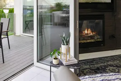 a living room with a fireplace on a porch at Piermont Waterfront Villa! in Piermont