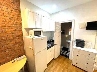 a small kitchen with a refrigerator and a microwave at Nest 1 bedroom Aparthotel with kitchenette in New York