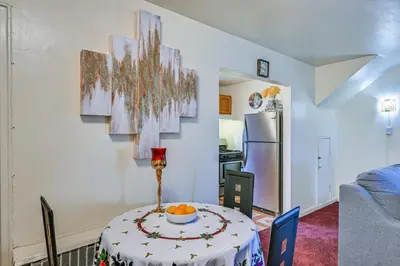a dining room with a table and a refrigerator at Mount Vernon Getaway - 4 Mi to the Bronx Zoo! in New Rochelle