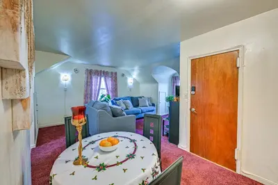 a living room with a table and a couch at Mount Vernon Getaway - 4 Mi to the Bronx Zoo! in New Rochelle