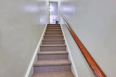 a staircase in a house with a stair case at Mount Vernon Getaway - 4 Mi to the Bronx Zoo! in New Rochelle