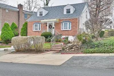 a brick house with a landscaping in front of it at Mount Vernon Getaway - 4 Mi to the Bronx Zoo! in New Rochelle