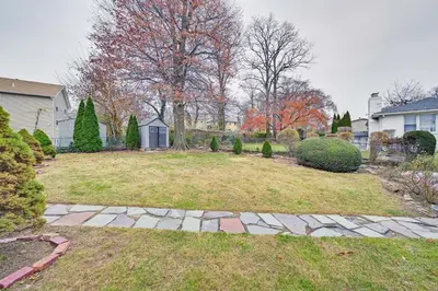 a yard with a stone walkway in a house at Mount Vernon Getaway - 4 Mi to the Bronx Zoo! in New Rochelle