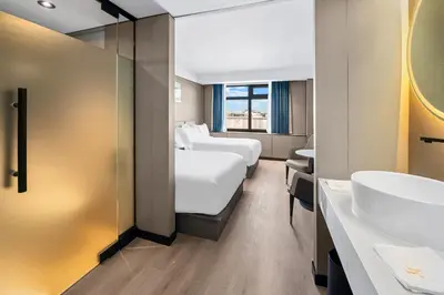 a hotel room with two beds and a sink at Ly New York Hotel in College Point