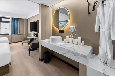 a hotel room with a sink and a mirror at Ly New York Hotel in College Point
