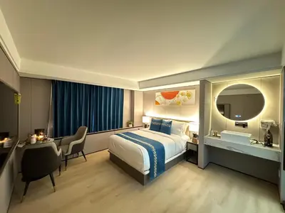 a hotel room with a bed and a desk at Ly New York Hotel in College Point