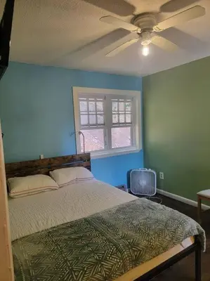 a bedroom with a bed and a ceiling fan at Rock Pad AirBnB in New Haven
