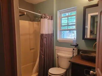a bathroom with a toilet and a sink and a shower at Rock Pad AirBnB in New Haven