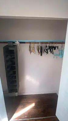 a room with a wall with a rack of shoes at Rock Pad AirBnB in New Haven