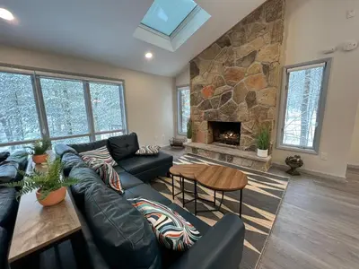 a living room with a couch and a fireplace at Open Concept & Stylish-HotTub-Sauna-Billiard-Poker-BBQ in East Stroudsburg