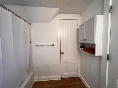 a bathroom with a white door and a shower at HOME Close to Yale New Haven Hospital in New Haven