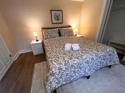 a bedroom with a bed with two towels on it at HOME Close to Yale New Haven Hospital in New Haven
