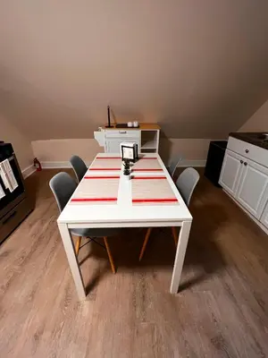 a white table with chairs in a room at HOME Close to Yale New Haven Hospital in New Haven