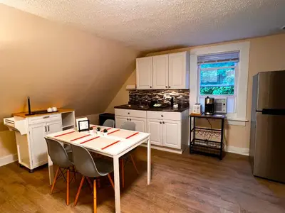 a kitchen with a table with chairs and a refrigerator at HOME Close to Yale New Haven Hospital in New Haven