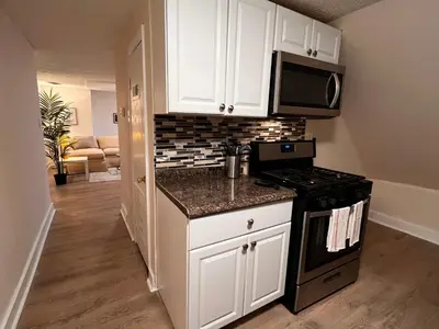 a kitchen with white cabinets and a stove at HOME Close to Yale New Haven Hospital in New Haven