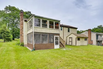 a house that is sitting on top of a yard at Vintage Windsor Home Private Yard and Covered Deck in Windsor