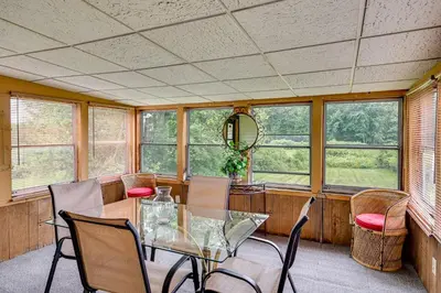 a dining room with a glass table and chairs at Vintage Windsor Home Private Yard and Covered Deck in Windsor