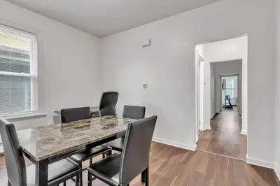 a dining room with a table and chairs at Frog Hollow Red Door Loft in Hartford