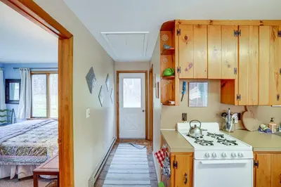 a kitchen with a stove and a bed in a room at Hawley Home with Deck 4 Mi to Berkshire East Resort in Hawley