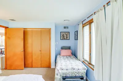 a bedroom with blue walls and a bed and a window at Hawley Home with Deck 4 Mi to Berkshire East Resort in Hawley