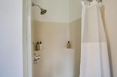 a shower with a white shower curtain in a bathroom at Hawley Home with Deck 4 Mi to Berkshire East Resort in Hawley