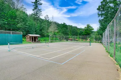 a tennis court with two tennis rackets on it at Hawley Home with Deck 4 Mi to Berkshire East Resort in Hawley