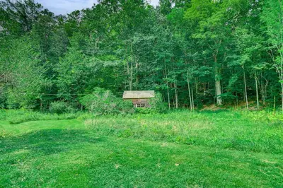 a small house in the middle of a field at Hawley Home with Deck 4 Mi to Berkshire East Resort in Hawley