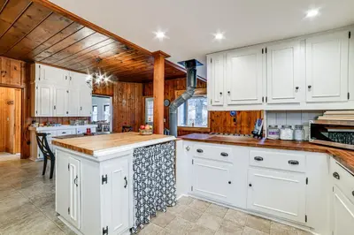 a kitchen with white cabinets and a wooden ceiling at Fly Creek Historic Home By Cooperstown! in Fly Creek