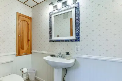 a bathroom with a sink and a mirror on the wall at Fly Creek Historic Home By Cooperstown! in Fly Creek