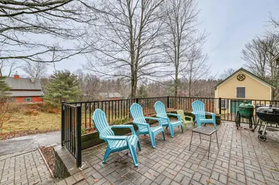 a group of blue chairs sitting on a patio at Fly Creek Historic Home By Cooperstown! in Fly Creek