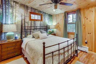 a bedroom with a bed and a ceiling fan at Cozy Lake Wallenpaupack Cabin with Community Perks in Lake Ariel